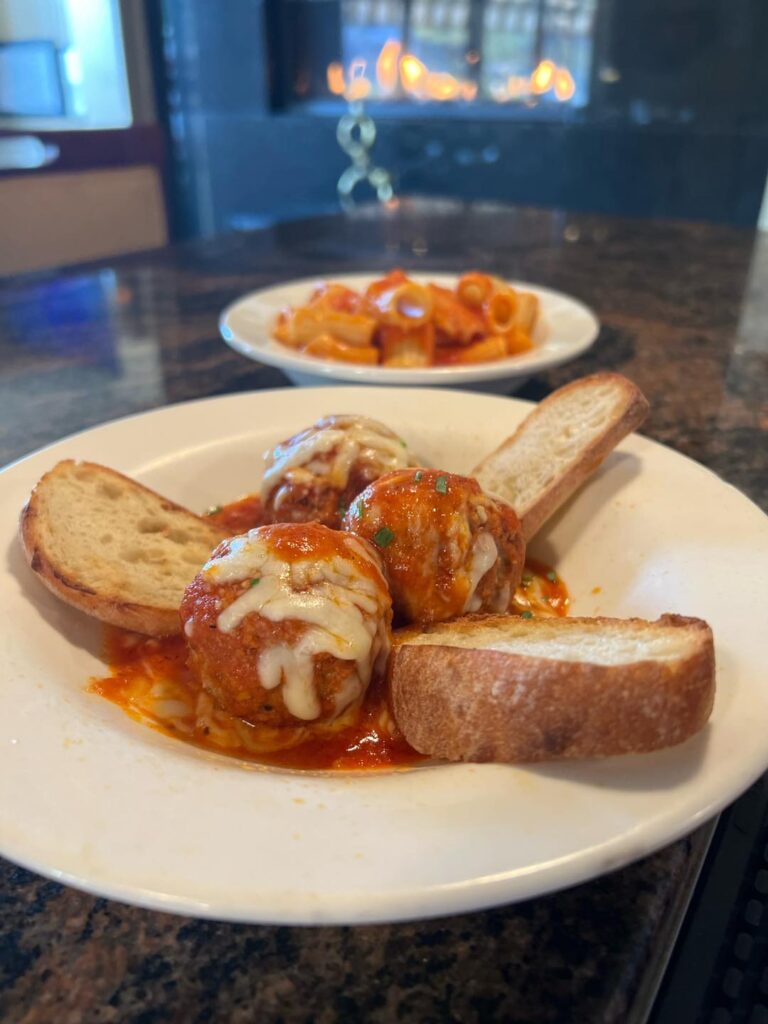 House meatballs with melted cheese and grilled bread