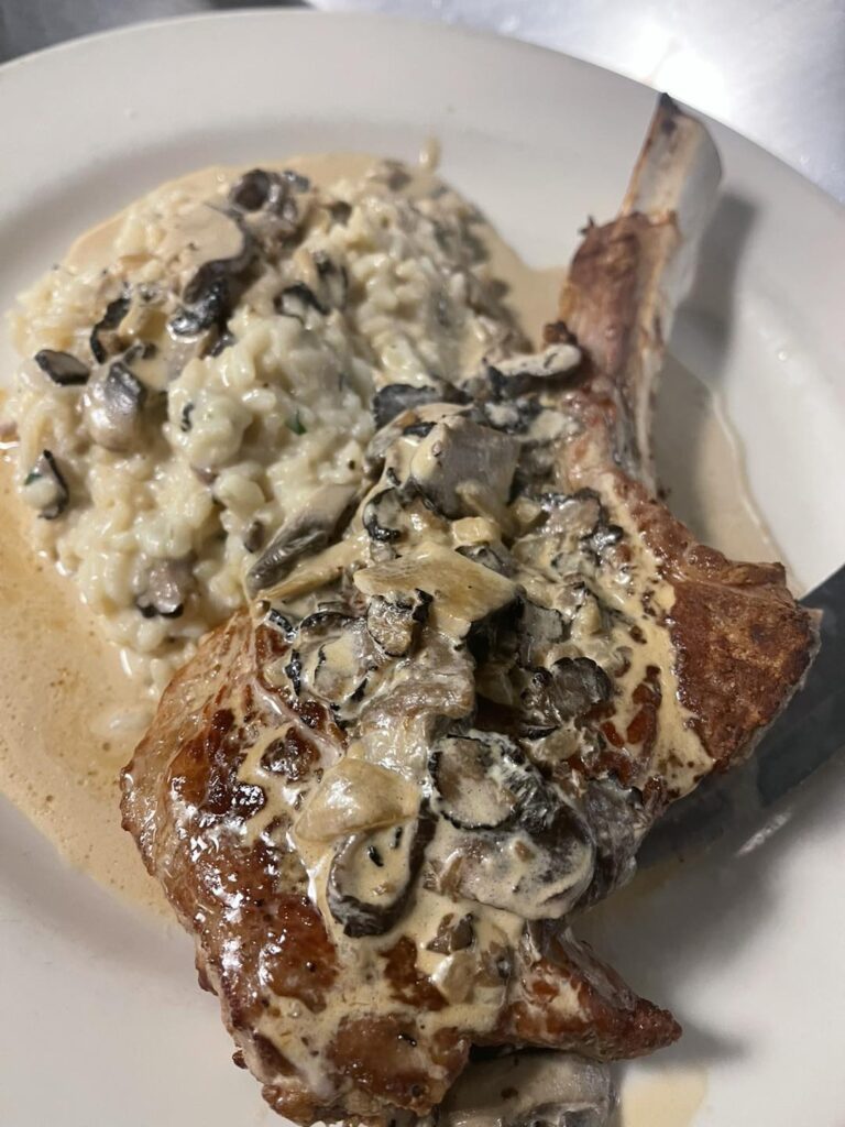 Veal chop with mushroom cream sauce and wild mushroom risotto