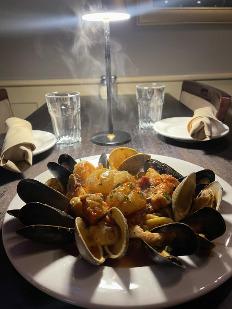 Zuppa di pescatore with mussels, clams, shrimp and fish over pasta