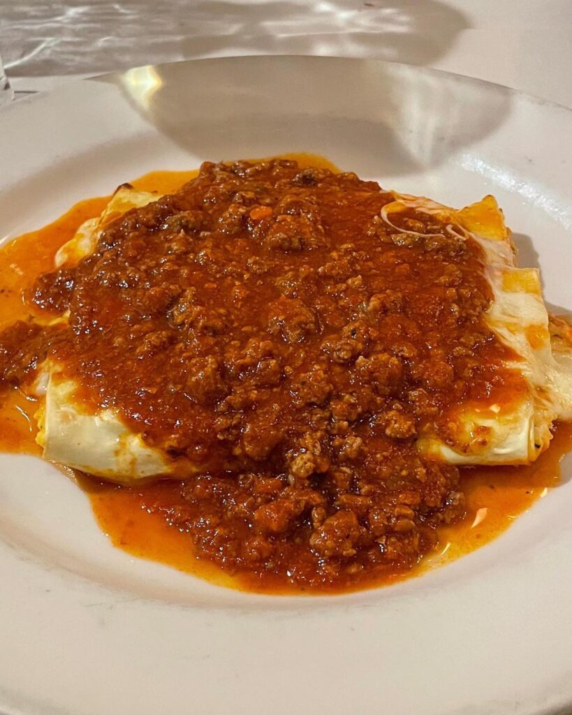 Meat lasagna under a rich bolognese sauce