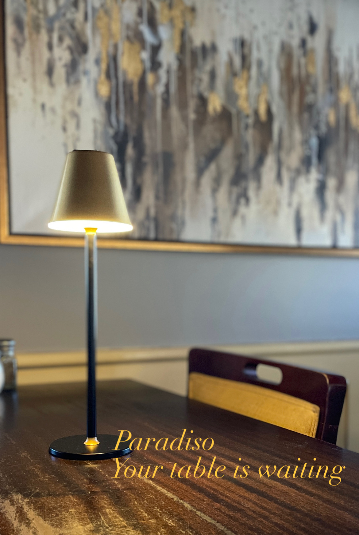Your table is waiting — a table lamp glowing in the Paradiso dining room