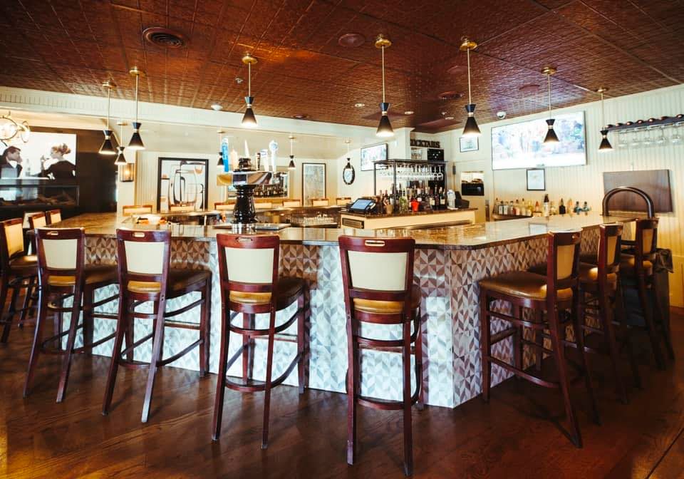 The newly renovated bar at Paradiso Ristorante with pendant lights and pressed-tin ceiling