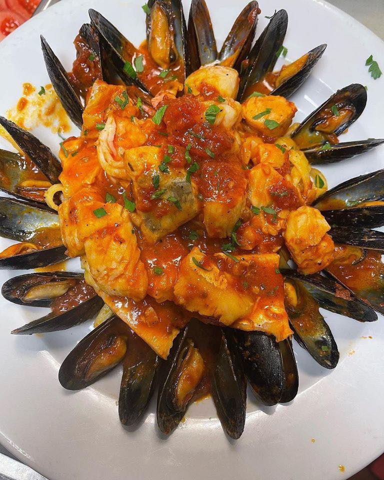 Frutti di mare with mussels, shrimp and fish in a spicy tomato sauce