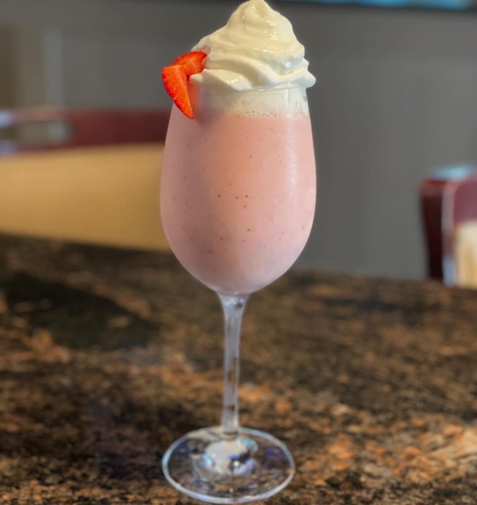 Strawberry cream dessert cocktail in a stemmed glass