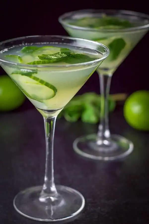 Two cucumber mint martinis with lime